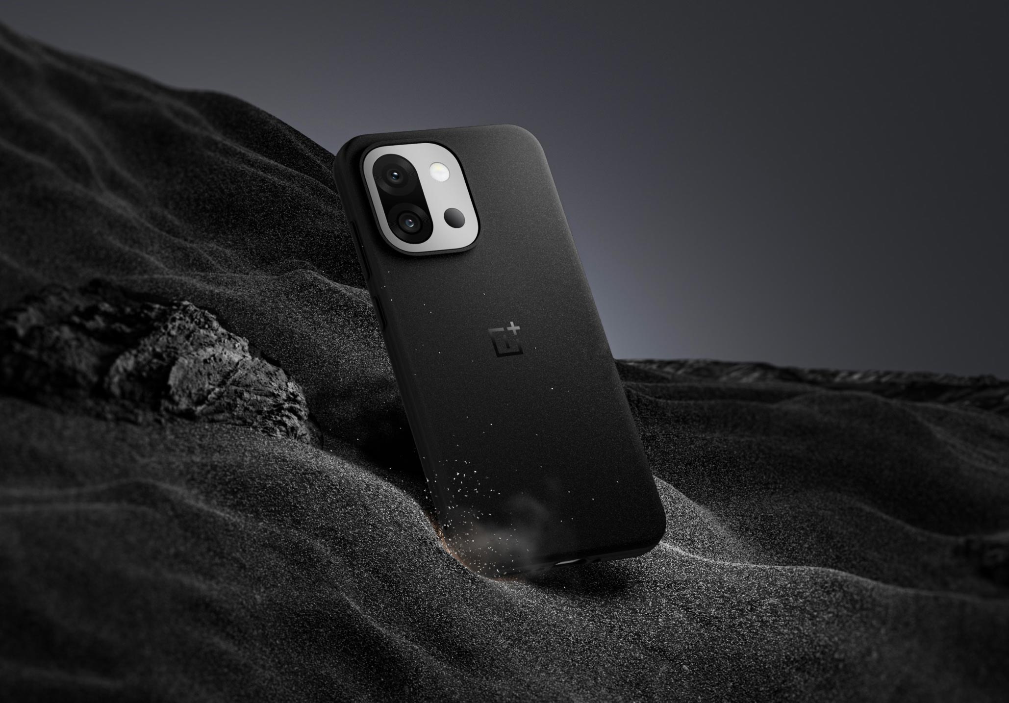 Black smartphone case on dark sand