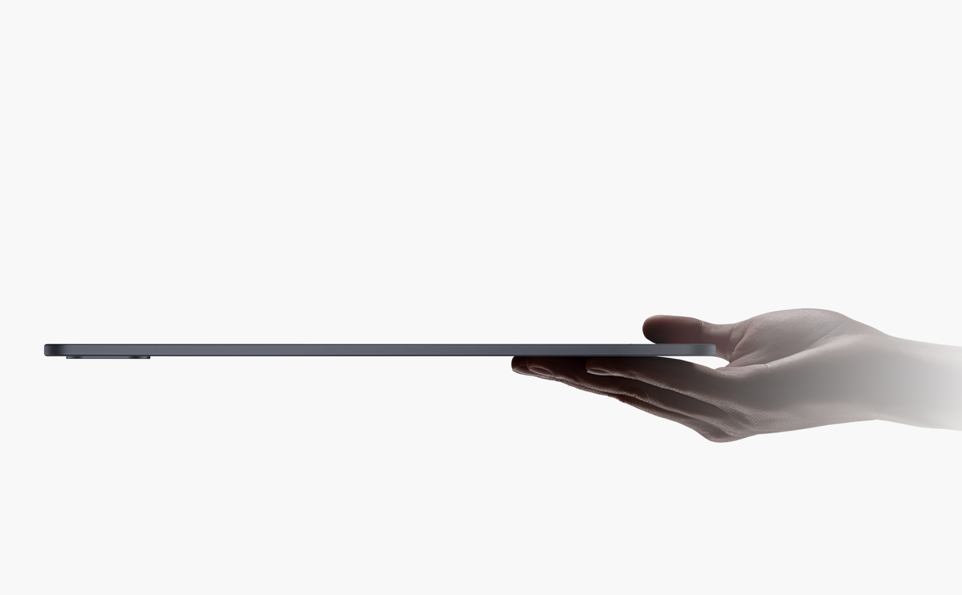 Sleek black rectangular tablet device held in hand