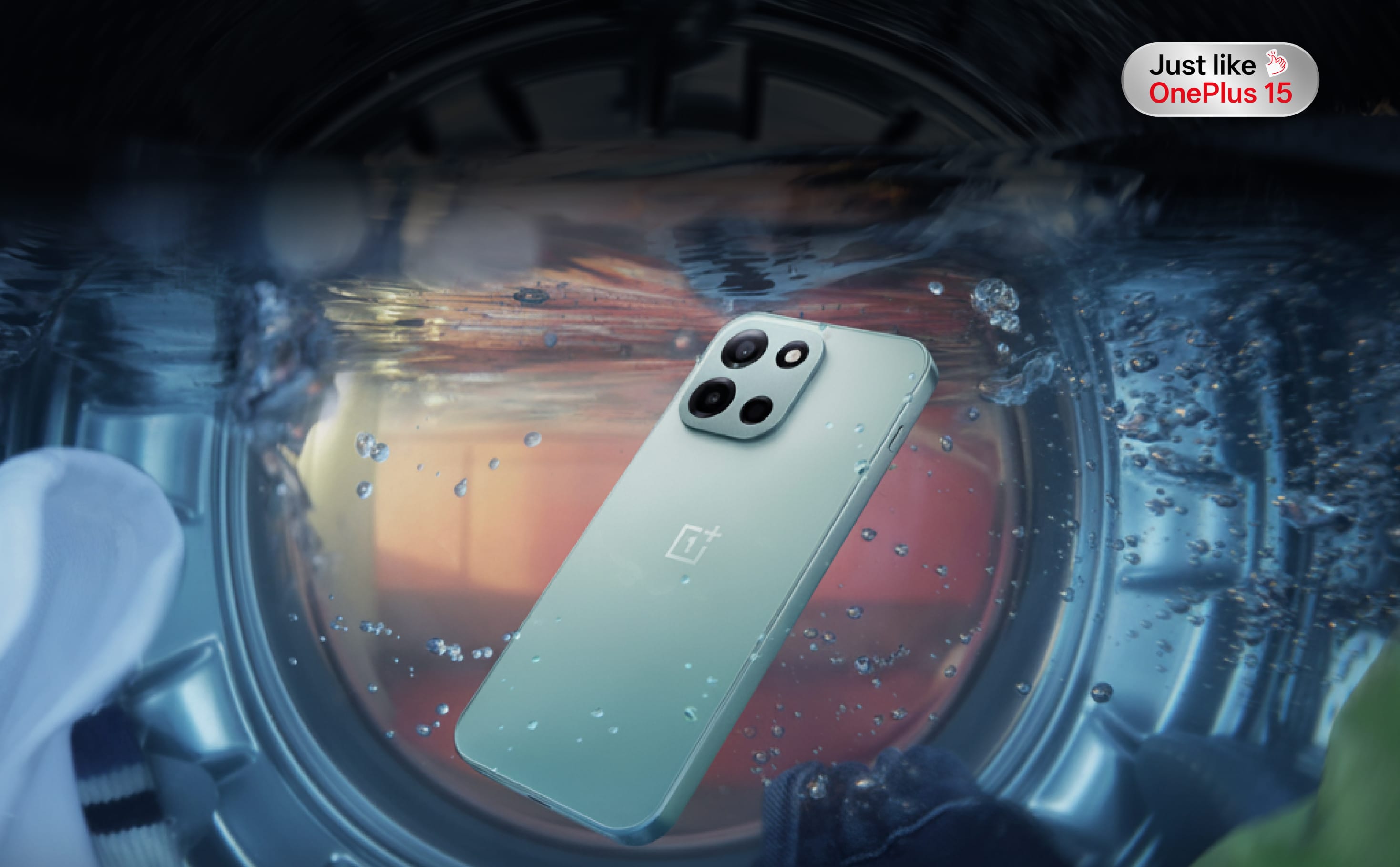 Sleek silver smartphone with four camera lenses floats in a water-filled container.